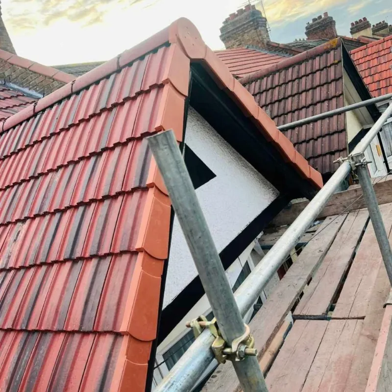 Gable-end re-roof with red pantiles by Phoenix Roofing