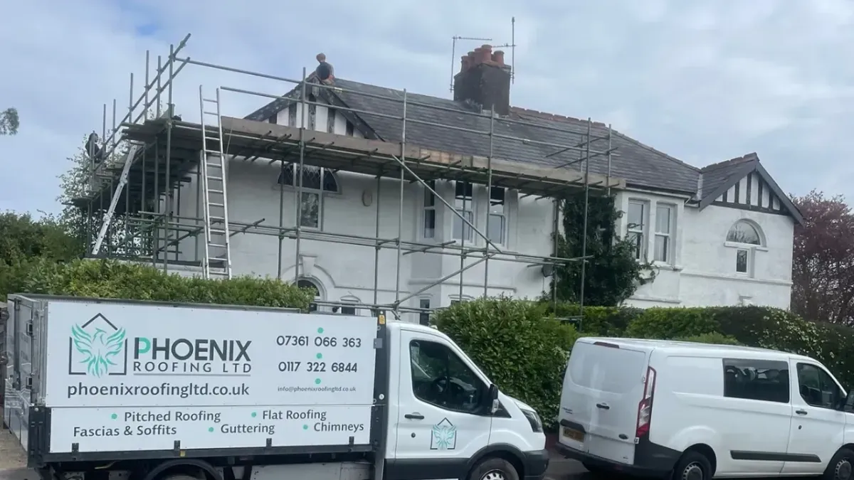 Phoenix Roofing vans and scaffolding outside a roof replacement in progress in Bristol