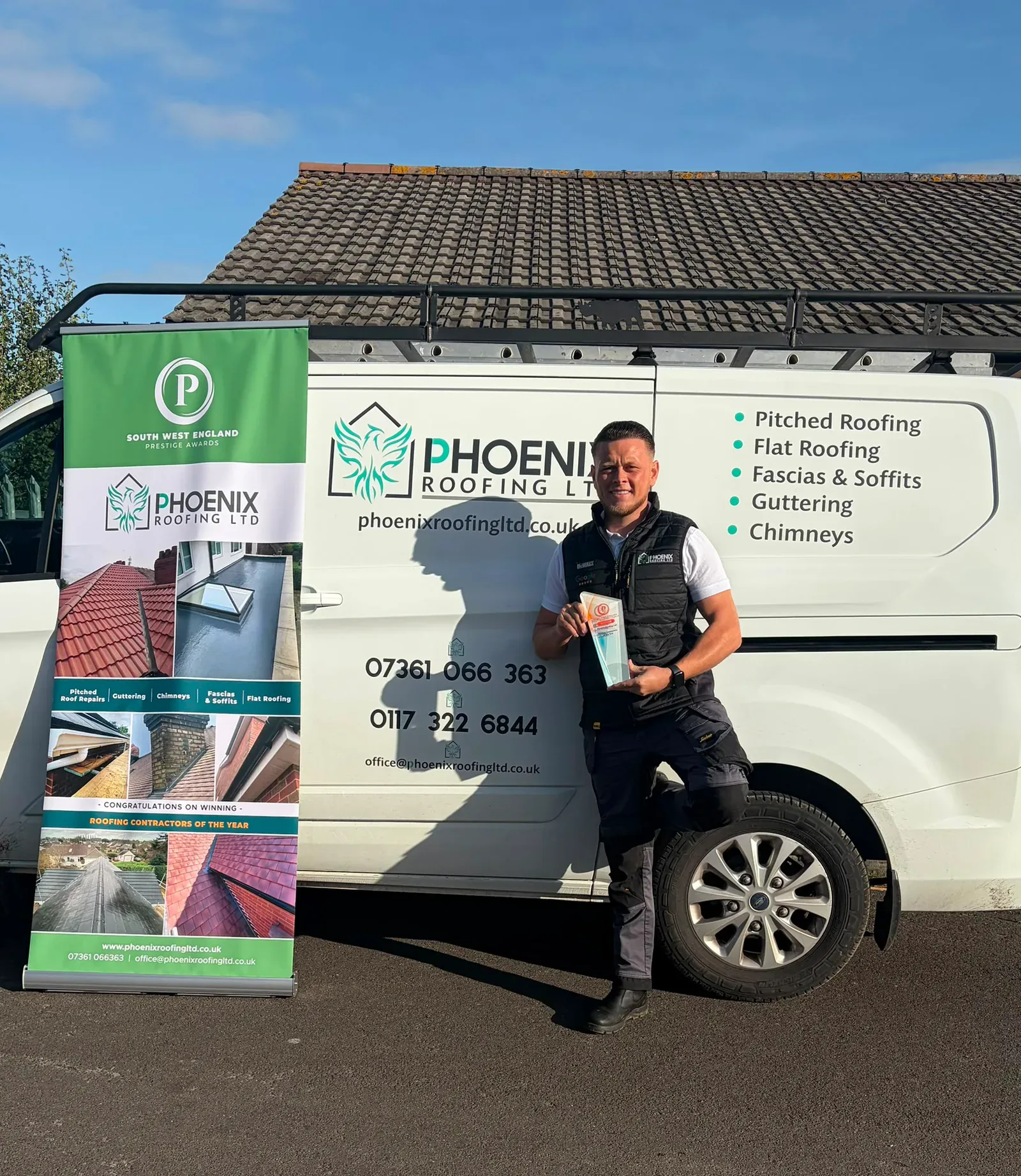 Phoenix Roofing owner with the South West England Prestige Awards Roofing Contractors of the Year award beside a Phoenix Roofing van
